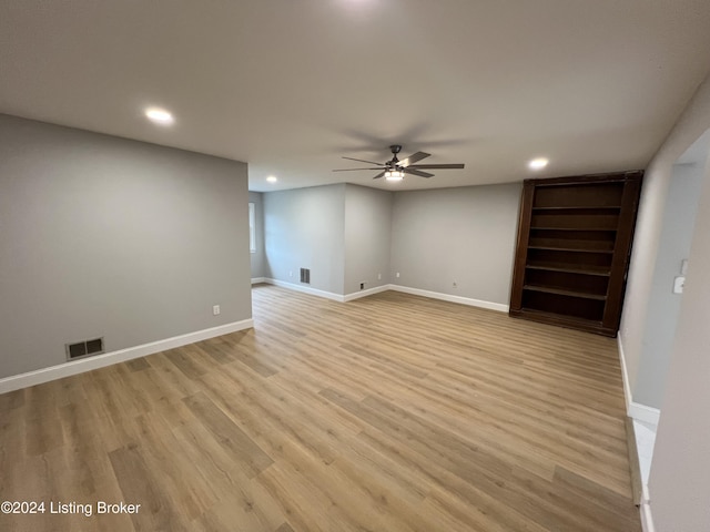 empty room featuring ceiling fan and light hardwood / wood-style flooring