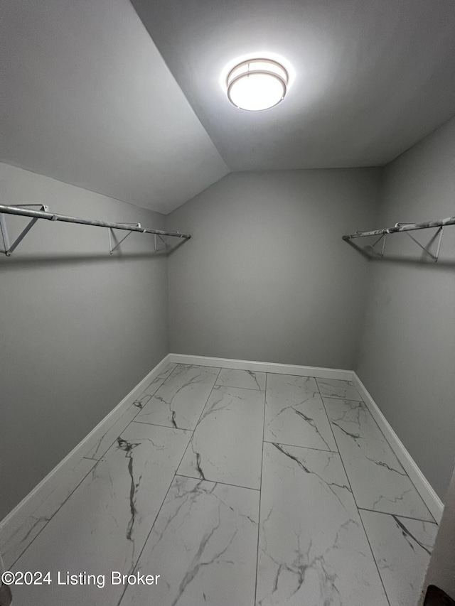 walk in closet with lofted ceiling