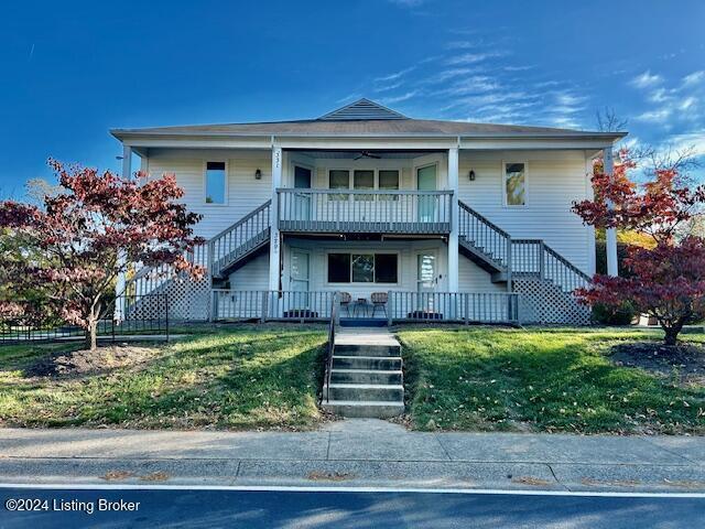 view of front facade with a front yard and a porch