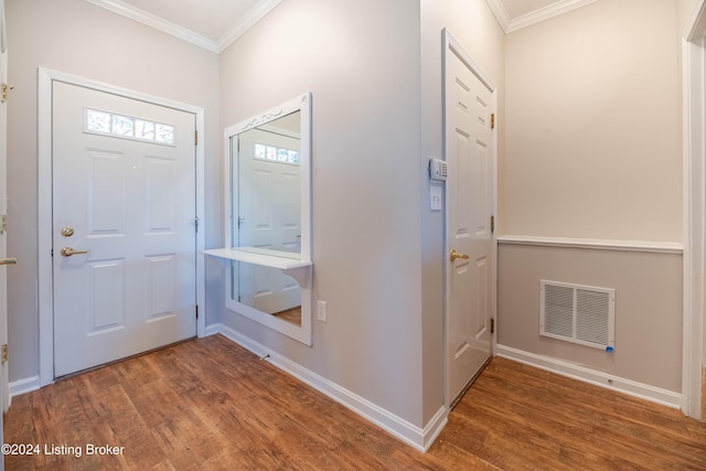 foyer entrance with hardwood / wood-style floors and ornamental molding