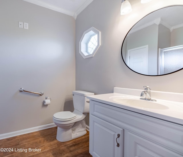 bathroom with wood-type flooring, vanity, toilet, and ornamental molding