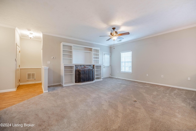 unfurnished living room featuring ceiling fan, light carpet, and ornamental molding