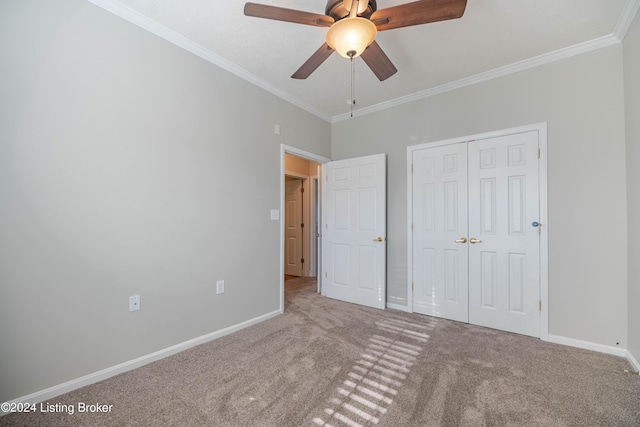 unfurnished bedroom featuring ceiling fan, a closet, carpet, and ornamental molding