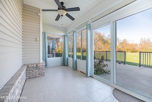 unfurnished sunroom with ceiling fan and wood ceiling