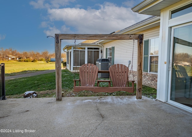 view of patio / terrace with central AC and a sunroom