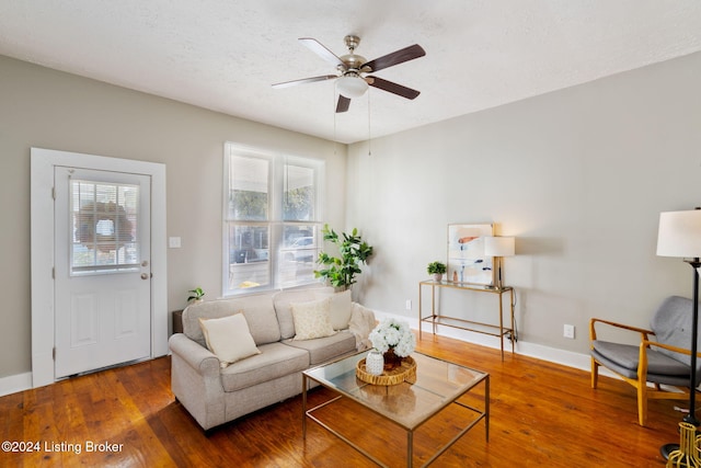 living room featuring ceiling fan and hardwood / wood-style flooring