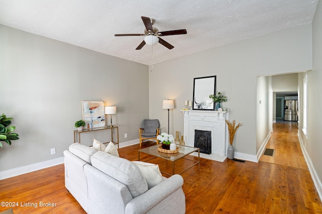 living room with hardwood / wood-style floors and a textured ceiling