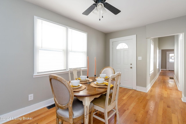 dining room with ceiling fan, light hardwood / wood-style floors, and a wealth of natural light