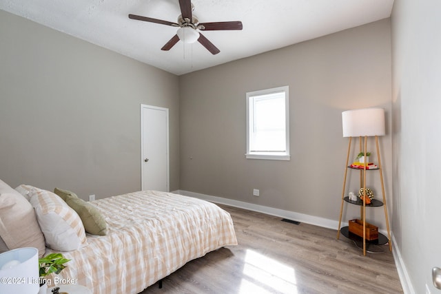 bedroom featuring light wood-type flooring and ceiling fan