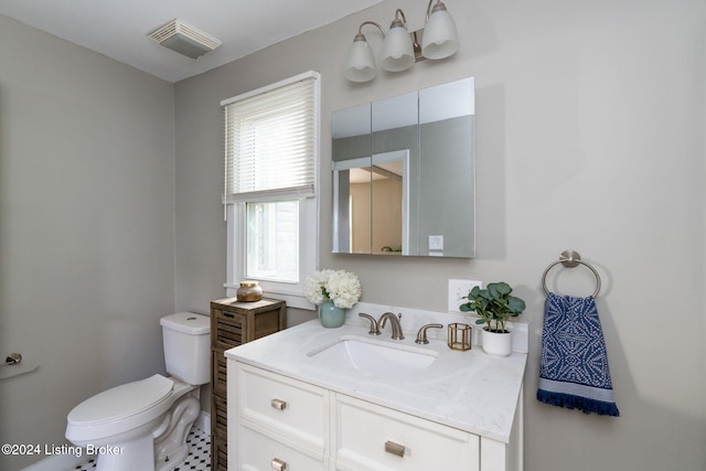 bathroom featuring tile patterned floors, vanity, and toilet