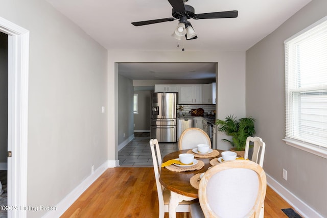 dining space featuring ceiling fan and light hardwood / wood-style flooring