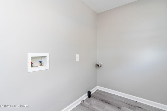 washroom with hookup for a washing machine and light hardwood / wood-style flooring