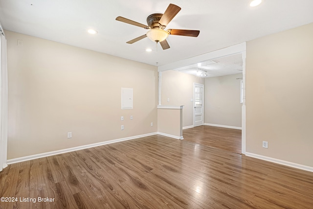 empty room with ceiling fan and hardwood / wood-style floors