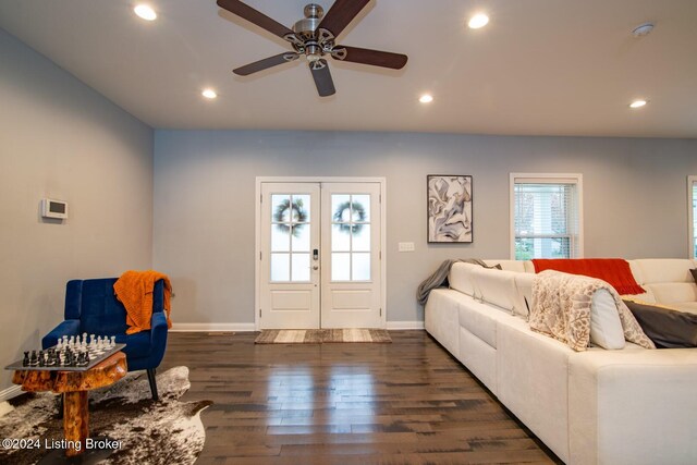 living room with french doors, ceiling fan, and dark wood-type flooring