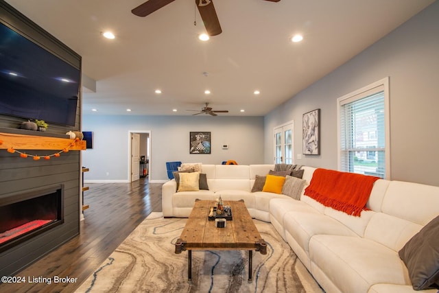 living room featuring dark hardwood / wood-style flooring and ceiling fan