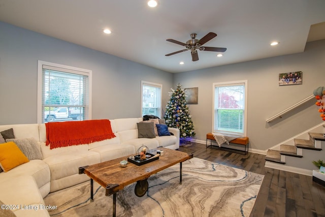 living room featuring dark hardwood / wood-style floors, ceiling fan, and a healthy amount of sunlight