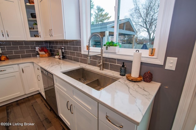 kitchen featuring white cabinetry and dishwasher