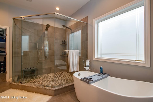 bathroom featuring tile patterned floors and independent shower and bath