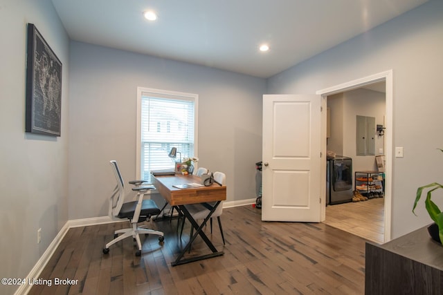 office featuring hardwood / wood-style floors, washer / dryer, and electric panel