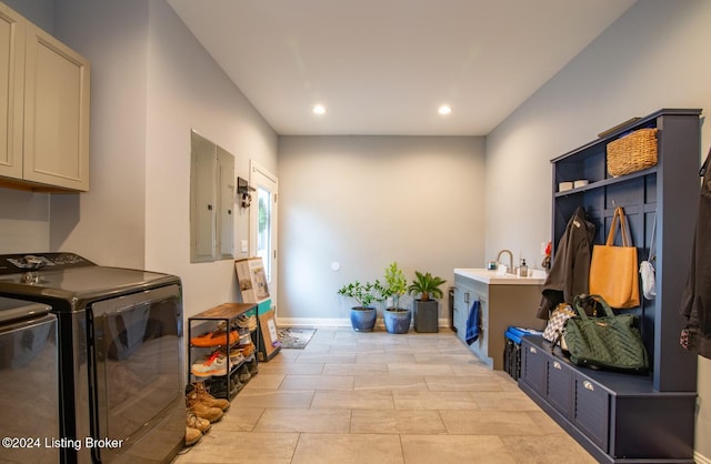 laundry area with sink, cabinets, electric panel, washer and clothes dryer, and light tile patterned floors