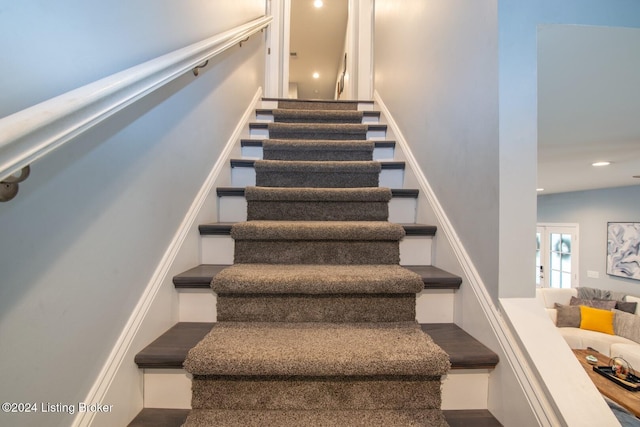 stairs with vaulted ceiling