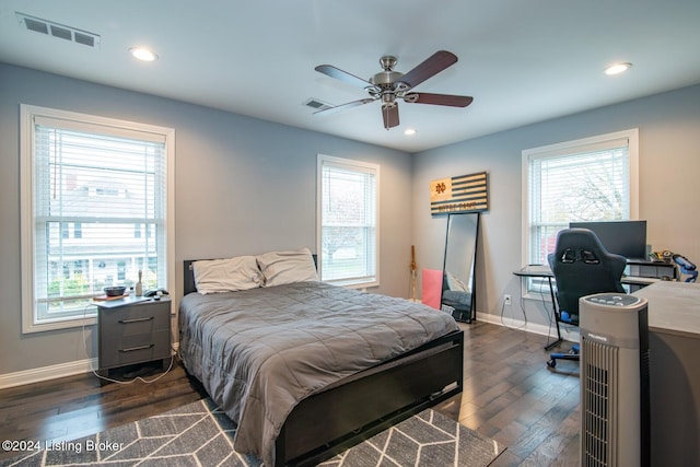 bedroom featuring multiple windows, ceiling fan, and dark hardwood / wood-style floors