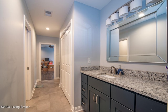 bathroom with ceiling fan and vanity