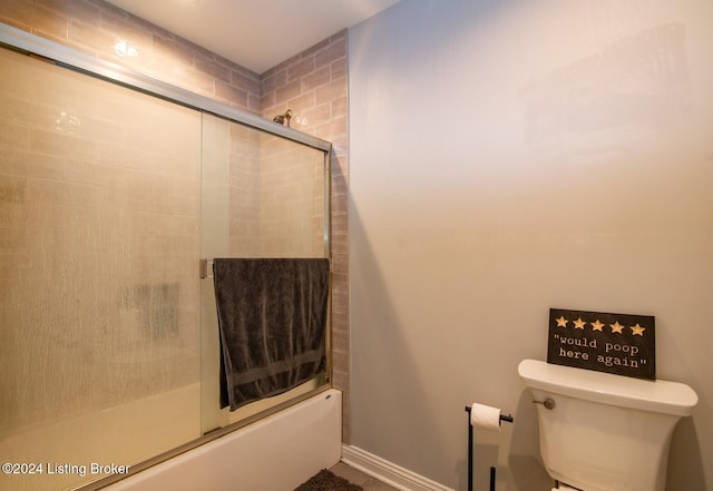 bathroom with shower / bath combination with glass door and toilet