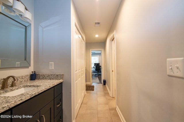 bathroom featuring tile patterned flooring and vanity