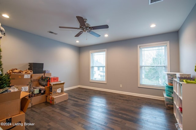 misc room with ceiling fan and dark wood-type flooring