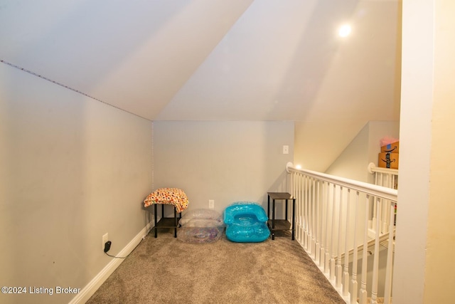 unfurnished room with carpet and vaulted ceiling