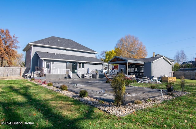 rear view of house featuring a patio area and a yard