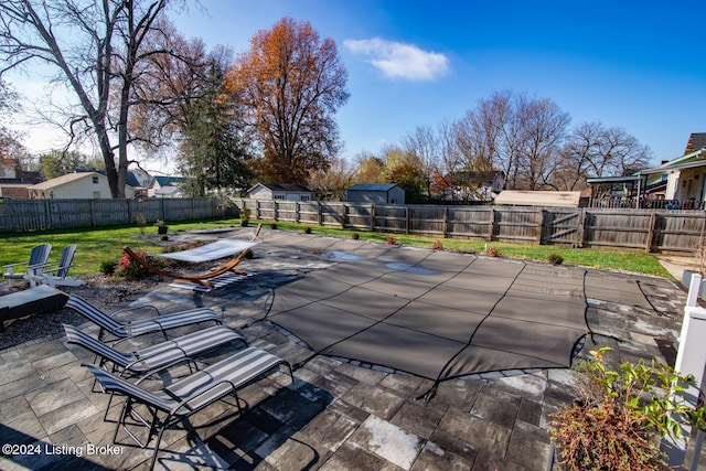 view of swimming pool with a yard and a patio area