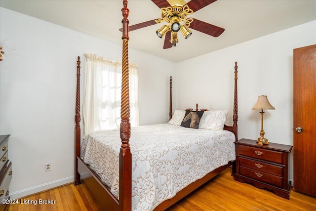 bedroom with ceiling fan and wood-type flooring