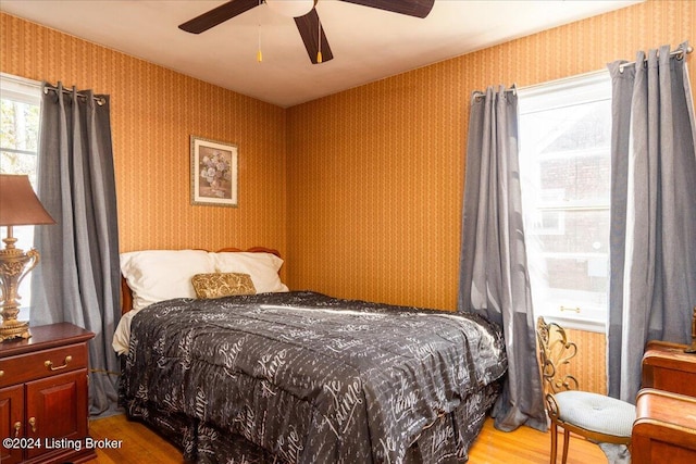 bedroom with hardwood / wood-style flooring and ceiling fan