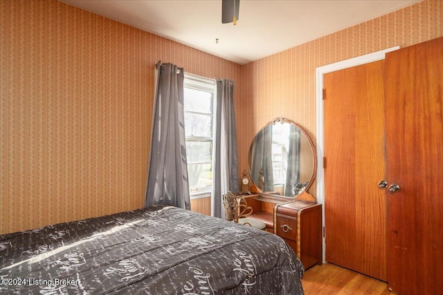 bedroom with light wood-type flooring and ceiling fan