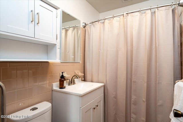 bathroom featuring decorative backsplash, vanity, and toilet