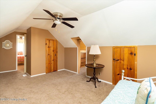 carpeted bedroom featuring ceiling fan and lofted ceiling