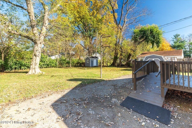 view of yard with a deck and a storage unit