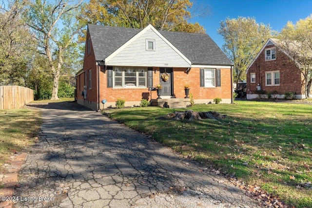 bungalow-style home featuring a front yard