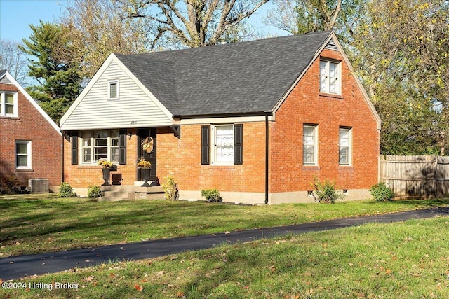 view of front of home with a front yard and cooling unit