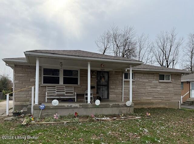 back of house with a yard and a porch