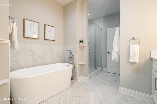 bathroom featuring vanity and shower with separate bathtub