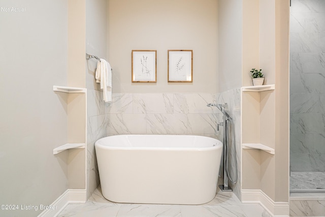 bathroom featuring tile walls and independent shower and bath