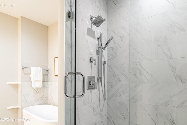 bathroom featuring separate shower and tub