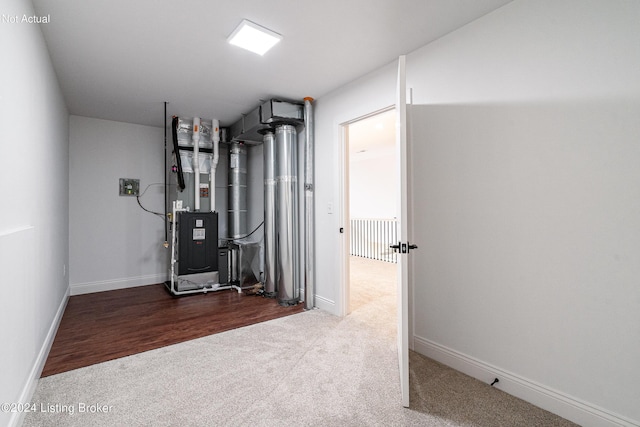 utility room featuring heating unit