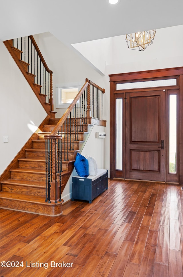 entrance foyer with a notable chandelier and hardwood / wood-style flooring