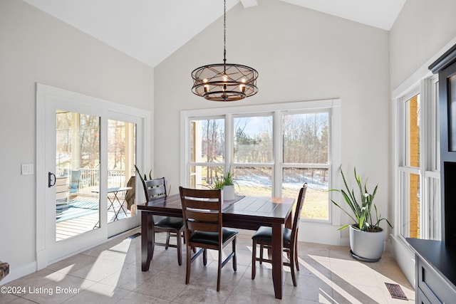 dining room featuring plenty of natural light, light tile patterned flooring, and a chandelier