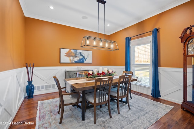 dining room with dark hardwood / wood-style floors and crown molding