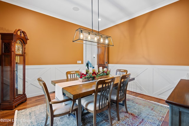 dining room with wood-type flooring and ornamental molding